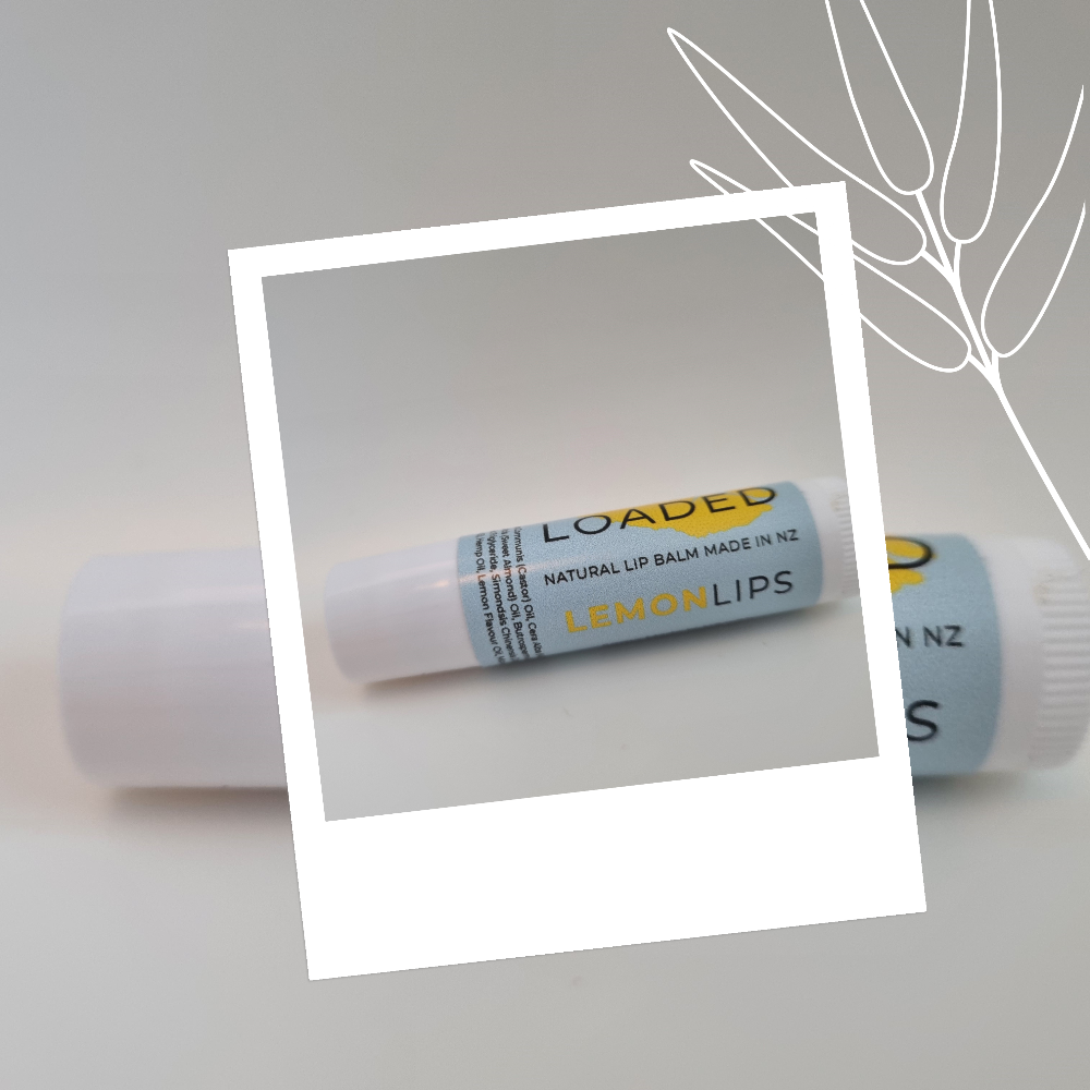 Loaded Lemon Lips lip balm on a light gray background