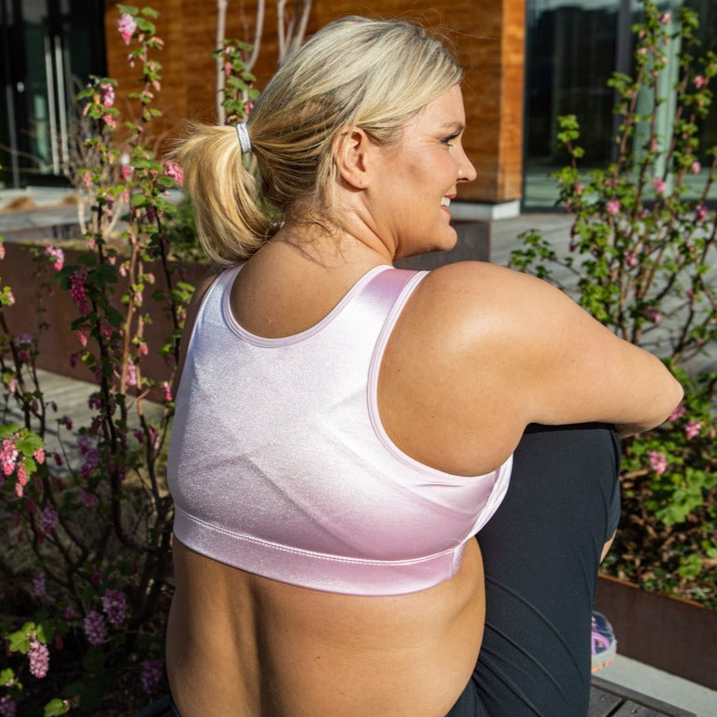 Curvy women outside wearing Enell Sports Bra showing the full support back view