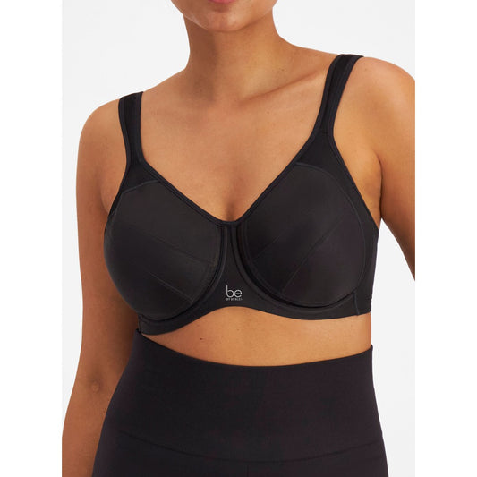 Black bra worn by a model on a white background