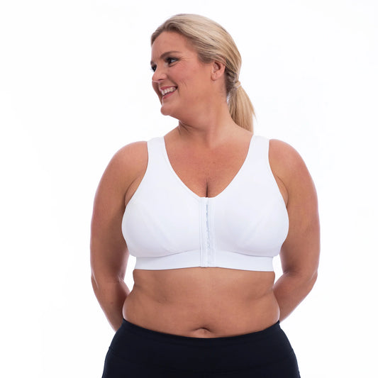 Active woman wearing the Enell LITE in White showing the front with easy hook and eye opening